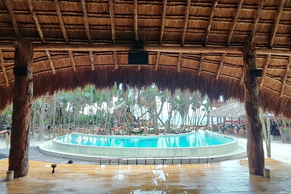Palapa con bocinas en las vigas, frente a la alberca y la playa