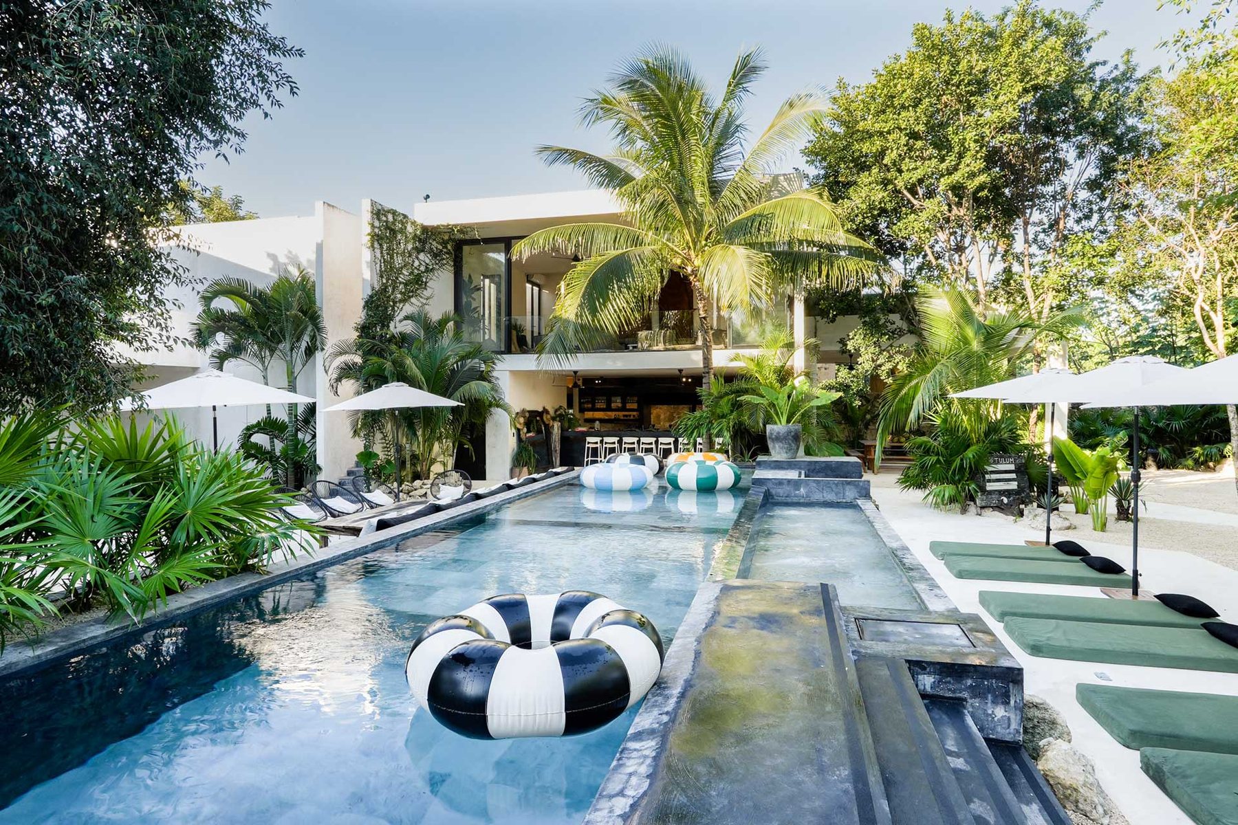 Pool and loungers with the house behind