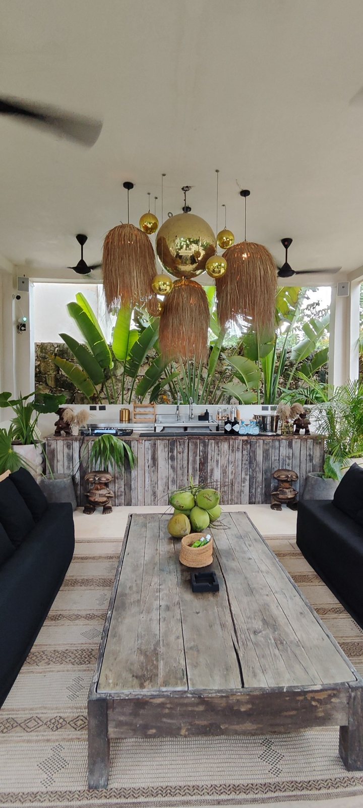 Lounge with palm lamps and gold mirror balls above the bar