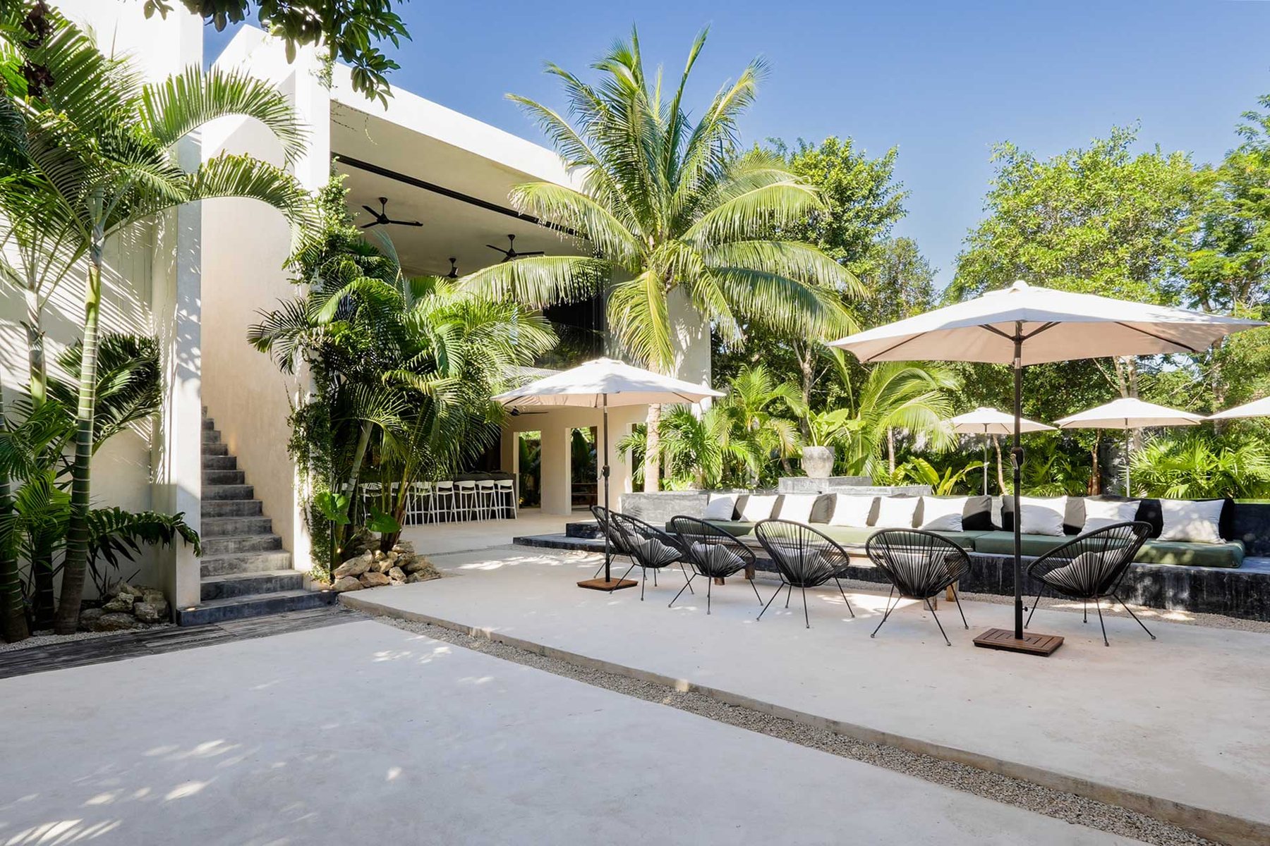 Terrace with umbrellas and chairs beside the house