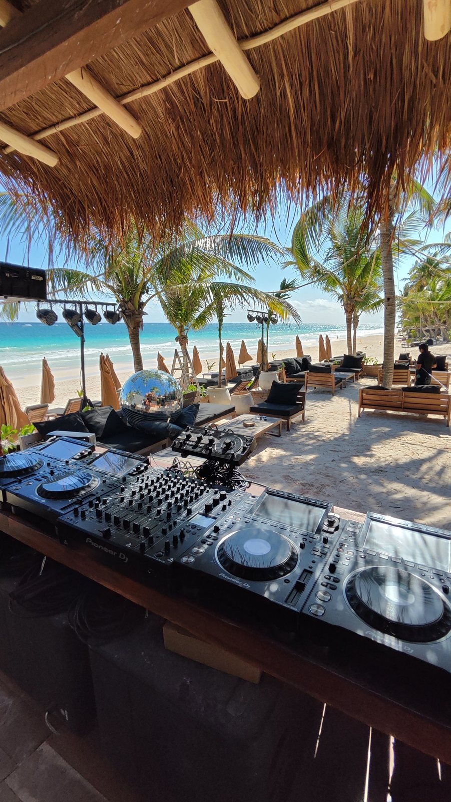 View from the booth toward the loungers, palms and sea