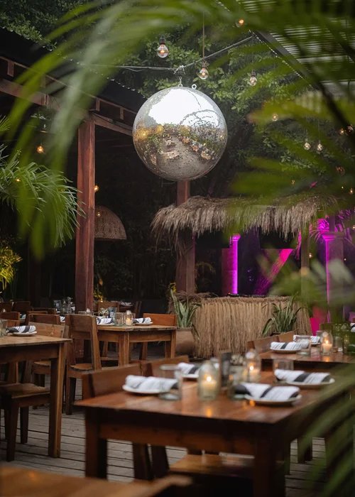 Mirror ball above the tables and the palm bar