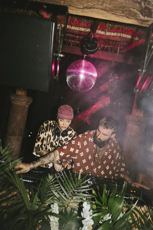 DJs in the booth with loudspeakers on each side