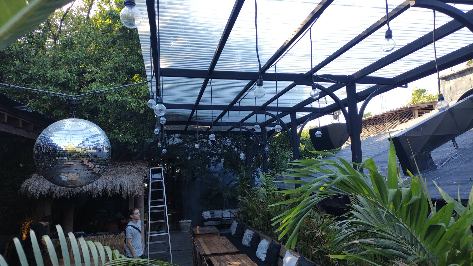 Covered terrace with a mirror ball and a loudspeaker on the frame